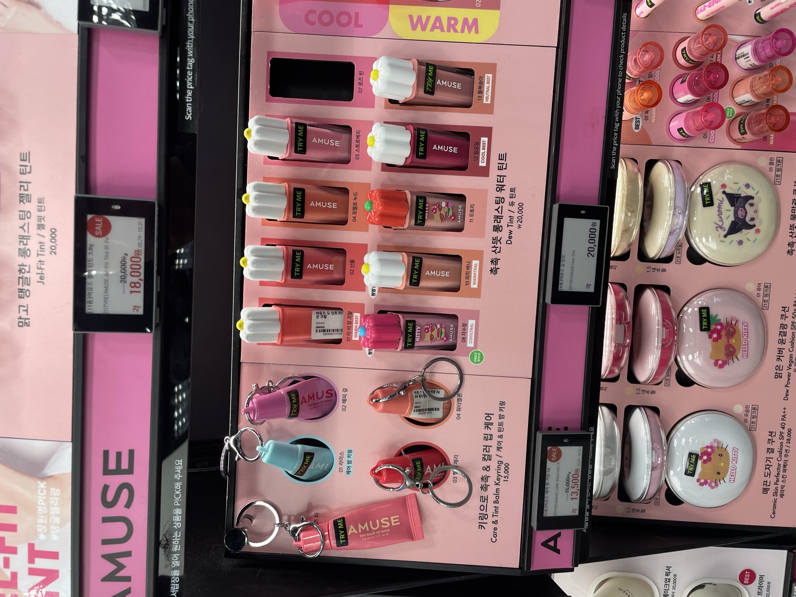 Amuse x Hello Kitty Dew Tints and Jel-Fit Tints display at Olive Young, showing cool and warm shade ranges with tester bottles
